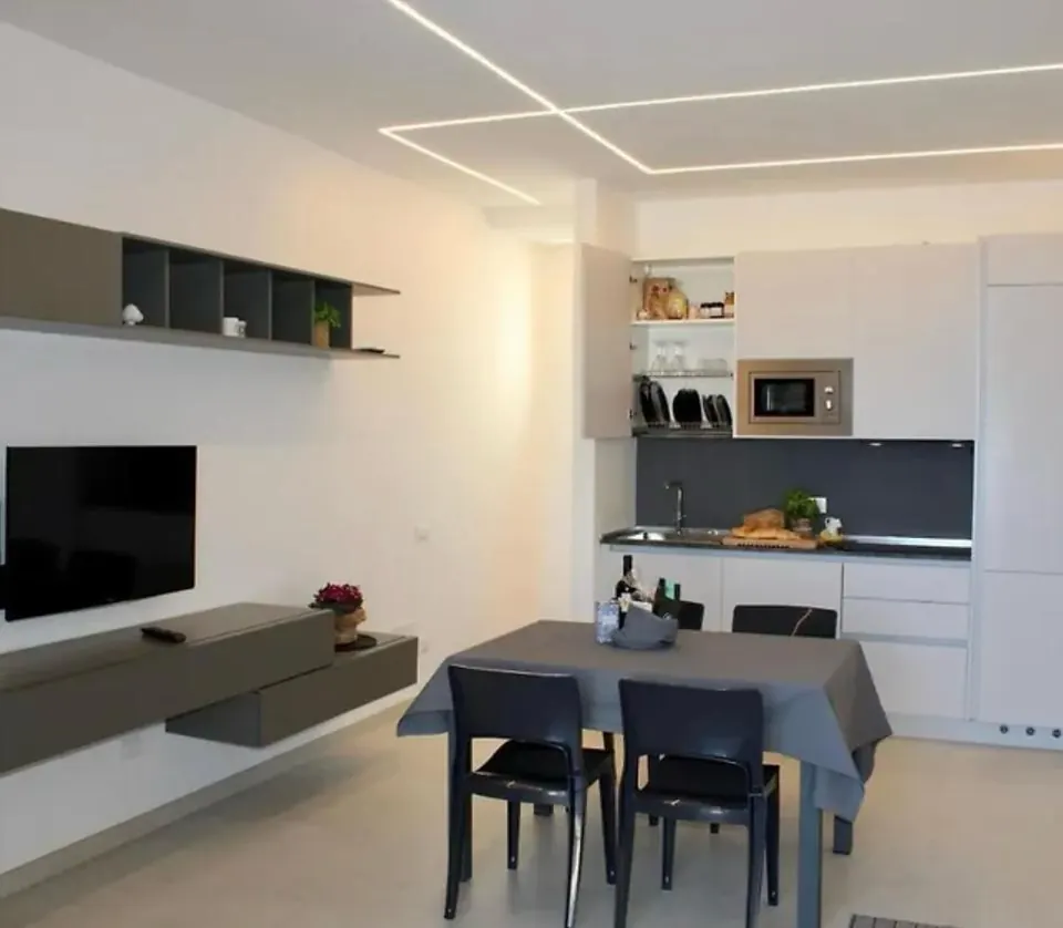 Living area with dining table and open kitchen